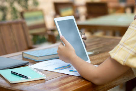 Image of document with charts on background of male and female working , business conceptの写真素材