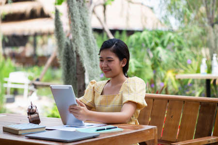 Image of document with charts on background of male and female working , business conceptの写真素材