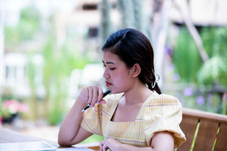 Image of document with charts on background of male and female working , business conceptの写真素材