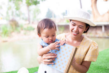 Mother and daughter relax and read a bookの写真素材