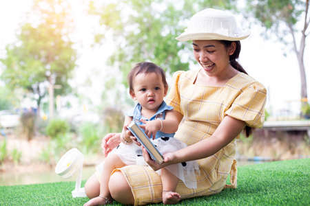 Mother and daughter relax and read a bookの写真素材
