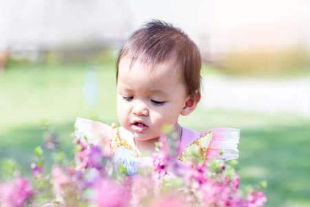 happy girl watching the flower garden