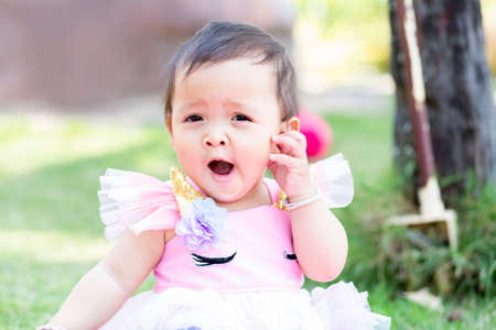 The daughter relaxes with bright eyes.の写真素材