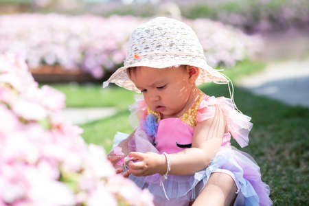 happy girl watching the flower gardenの写真素材