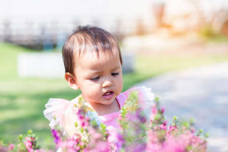 happy girl watching the flower gardenの写真素材
