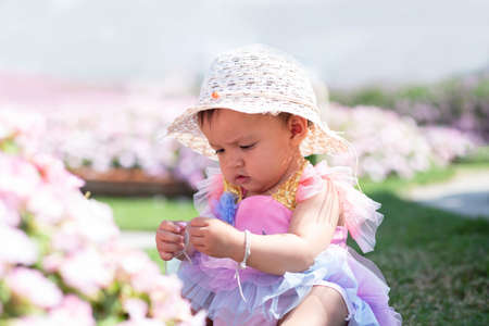 happy girl watching the flower gardenの写真素材