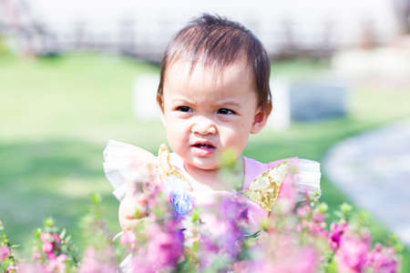 happy girl watching the flower gardenの写真素材