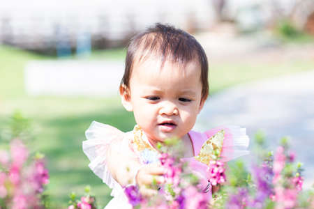 happy girl watching the flower gardenの写真素材