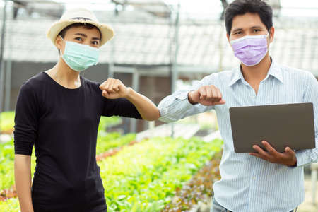 Organic farmer stands a great thumbs up.の写真素材