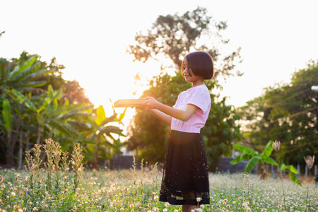 child little girl with  reading a bookの写真素材