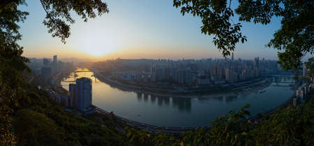 The river is called the Jialing River and this is Chongqing, China. Towards the end of the evening, the city view on the bank of the riverの写真素材