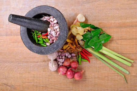 Thai spices ingredient for spicy food over wooden texture and backgroundの写真素材