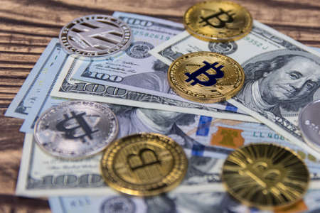  bitcoins, litecoin and ethereum on old wooden table