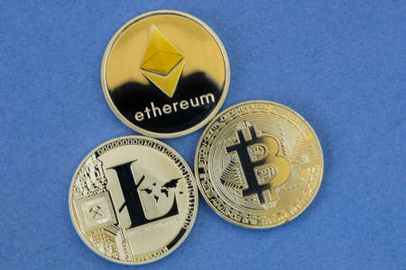 litecoin, bitcoin and ethereum lie on blue background