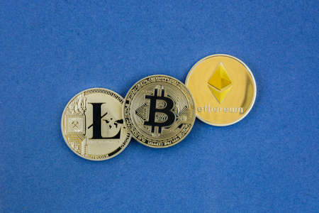 litecoin, bitcoin and ethereum lie on blue background
