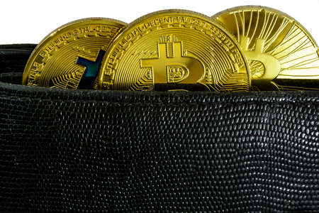 three bitcoin lie in black leather wallet