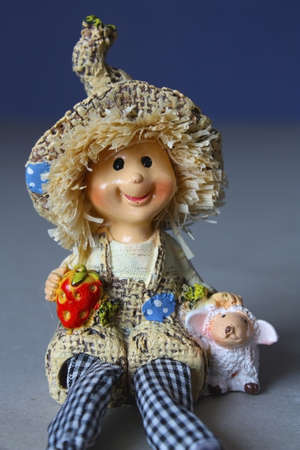 Ceramic doll cute baby on a blue backgroundの写真素材