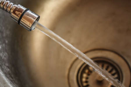 Running faucet with water flowingの写真素材