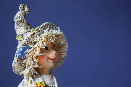 Ceramic doll cute baby on a blue backgroundの写真素材