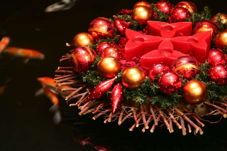 Asian Christmas with koi fishes swimming in a pondの写真素材