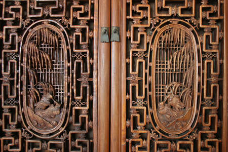 frontal view of door with wood carvingsの写真素材