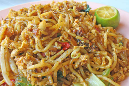 plate of famous fried egg noodles from malaysiaの写真素材