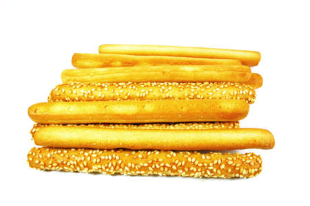 mix of butter and sesame breadsticks on white