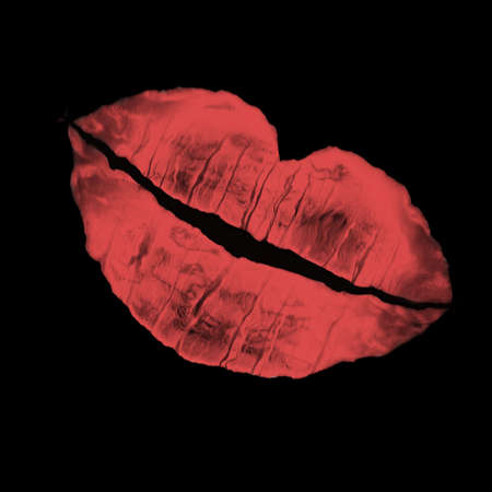 imprint of woman's lip on a black color backgroundの写真素材