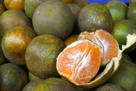 juicy mandarin oranges on display at the marketの写真素材