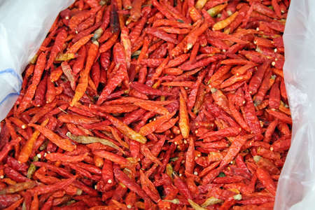 dried red chillies on display at the marketの写真素材