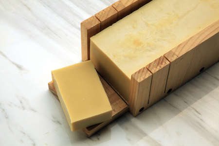Handcrafted castille soap made with extra virgin olive oil displayed on marble backdropの写真素材