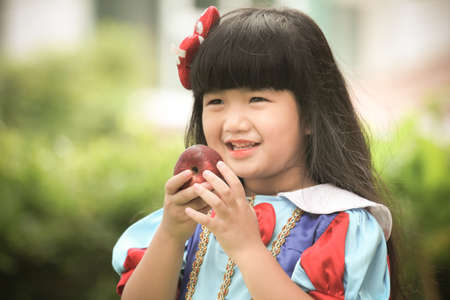 Little girl snow white with apple,Snow White's lovely.の写真素材