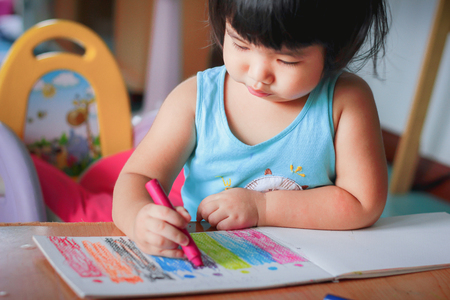 cute girl drawing with colourful crayon ,kids Coloringの写真素材