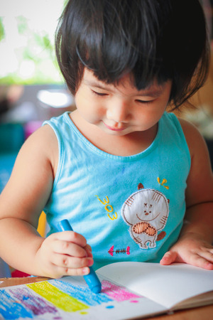 cute girl drawing with colourful crayon ,kids Coloringの写真素材