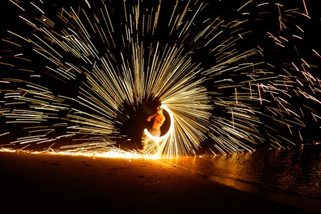 Man playing fire batonの写真素材