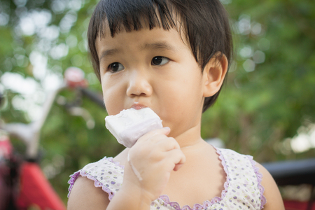 Cute Toddler Girl Eating Ice-Cream ,Girls eat ice-cream, Asian girl eat ice-creamの写真素材