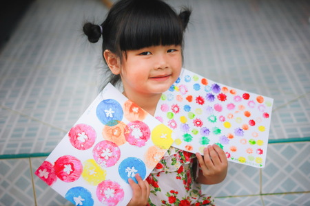 Asian girl play color water pump with fruits and vegetables,Children color pump , Color pump, children pump , Activities for making fruit and vegetable water pumpsの写真素材