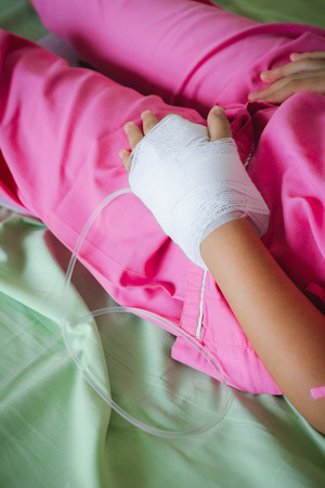 Patient is on drip receiving a saline solution , Salineの写真素材
