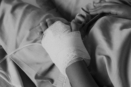 Patient is on drip receiving a saline solution , Salineの写真素材