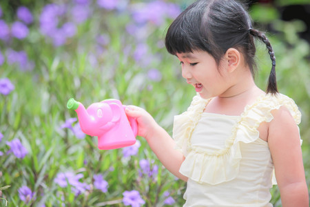 Asian little girl watering a tree , Asian Girl , Thailandの写真素材