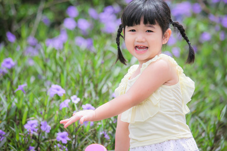 Asian little girl watering a tree , Asian Girl , Thailandの写真素材