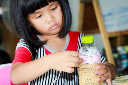Asian girls making jobs D.I.Y. vase with used water bottlesの写真素材
