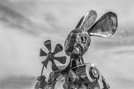 Metal rabbit sculpture holding flowerの写真素材