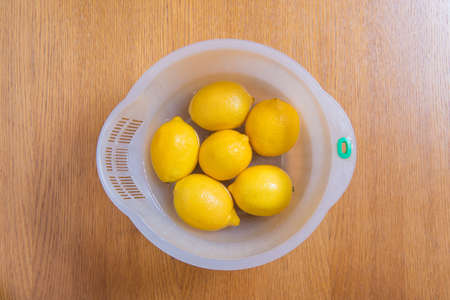 Fresh yellow lemons on a wooden background. sweet lime, vitamin c.の写真素材