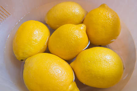 Fresh yellow lemons on a wooden background. sweet lime, vitamin c.の写真素材