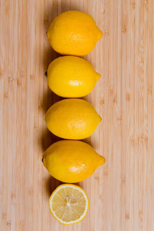 Fresh yellow Lemon slices on the old wooden table.の写真素材