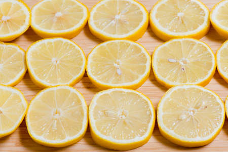 Fresh yellow Lemon slices on the old wooden table.の写真素材