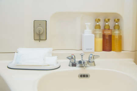 toiletry bag with travel toiletries, small plastic bottles of hygiene products and soap, Hotel Guest Room Suppliesの写真素材