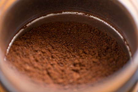 Coffee beans are ground into coffee powder by a grinderの写真素材