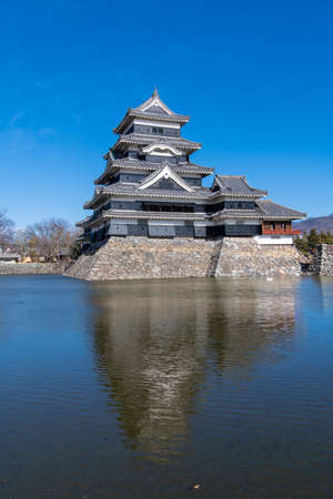 Matsumoto Castle in winter with beautiful snow-covered Northern Alps, Matsumoto Castle is listed as a National Treasure of Matsumoto, Japan.のeditorial素材